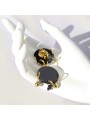 Earrings made in black plexiglass, gold-plated brass, and crystal.